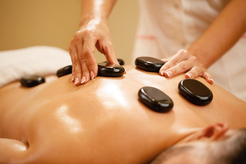 closeup-therapists-placing-hot-stones-man-s-back-during-lastone-therapy-spa